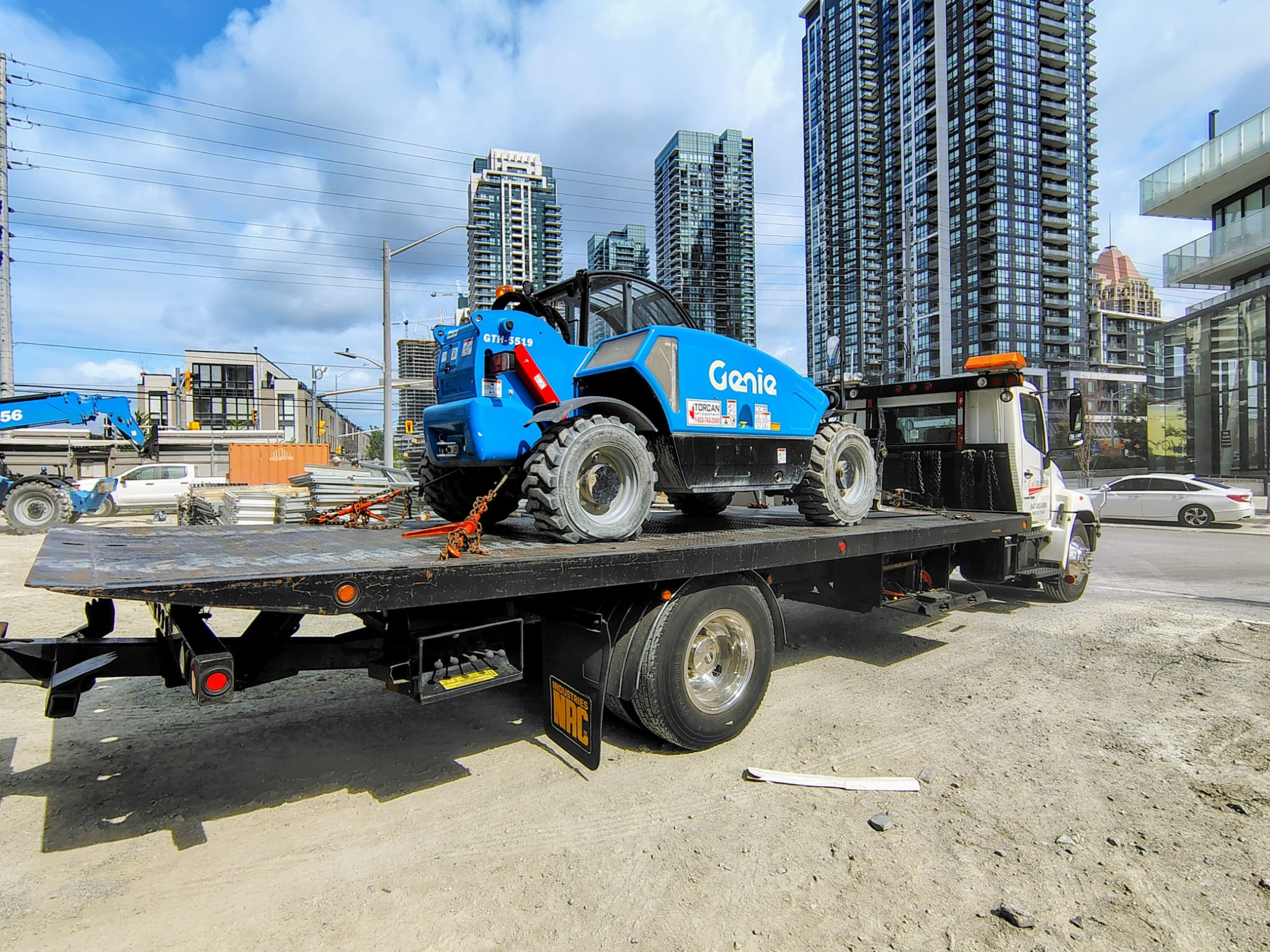 Genie telehandler on flatbed at construction site