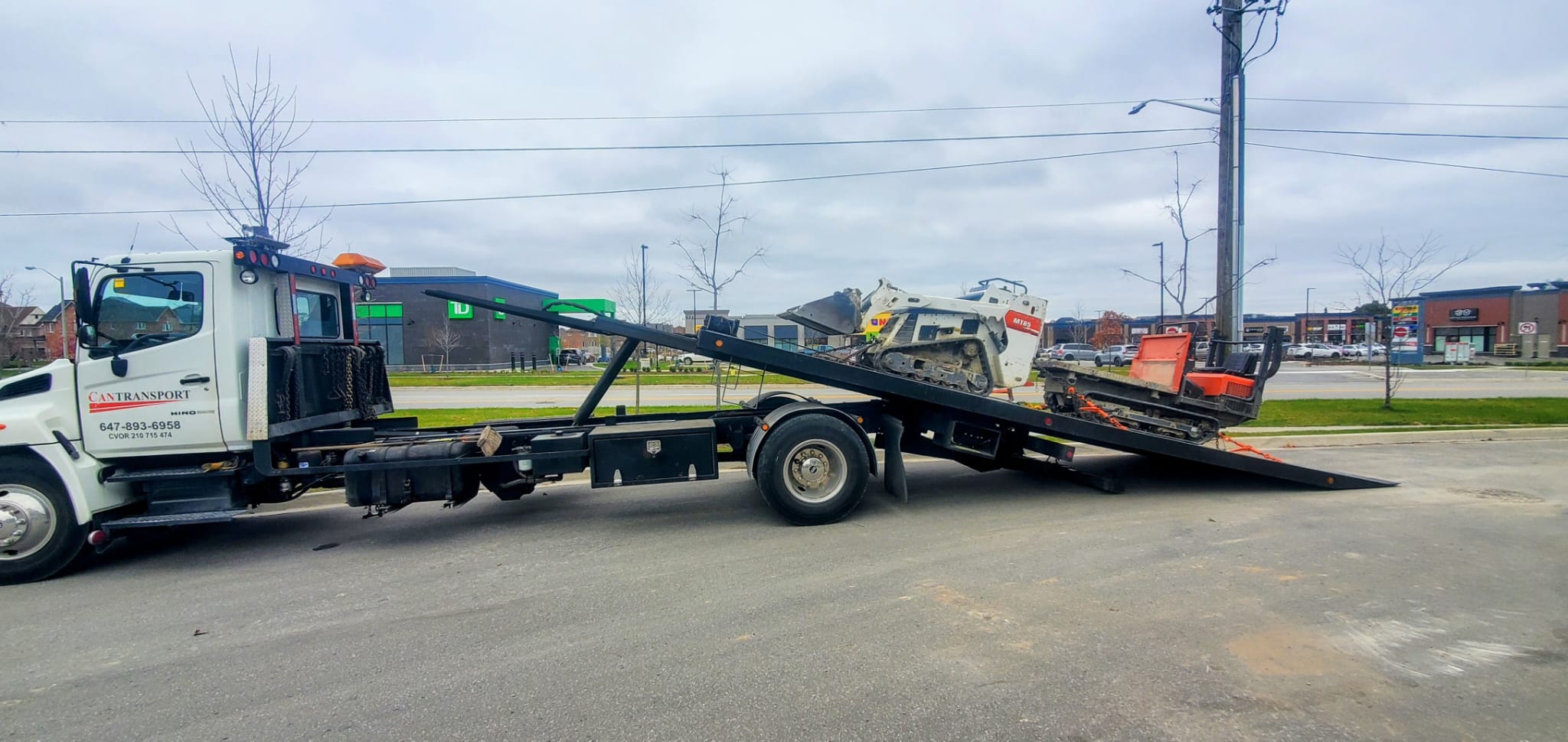 Bobcat tracked loader on tilt-deck truck