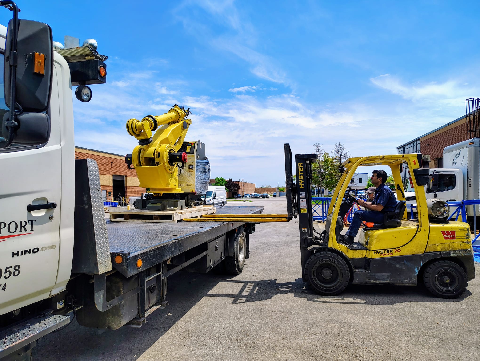 Industrial robots loaded on flatbed truck