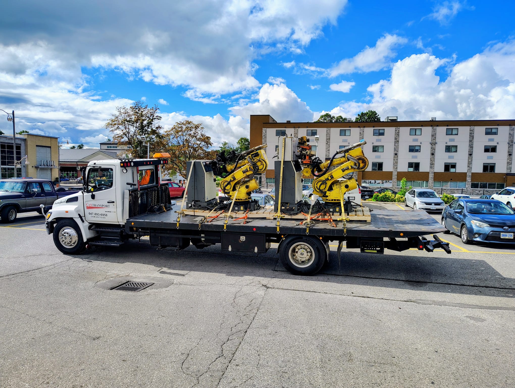 Caterpillar forklift on tilt-bed truck